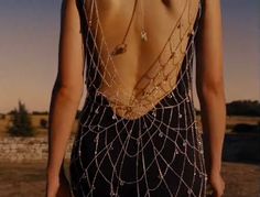 the back of a woman's dress with chains on it