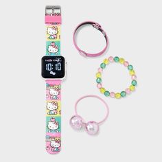 Add cute feline flair your kid's timekeeping with this Hello Kitty Watch Set. This set comes with a plastic watch boasting a convenient digital time display on a black square case, complemented by a colorful strap that fastens with a buckle, offering an adjustable and comfortable fit for your child. Adorned with cute Hello kitty drawings on the strap featuring yellow, pink and green striped bands, the watch is paired with a hair tie and two bracelets, adding a fan-favorite look to your child's o Hello Kitty Watch, Cute Hello Kitty, Watch Set, Black Square, Hair Tie, Green Stripes, Girls Shopping