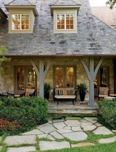 a house with stone walkways leading to the front door