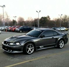 a black sports car parked in a parking lot