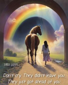 a woman walking down a dirt road next to a horse under a rainbow colored sky