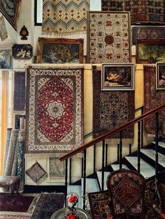 there are many rugs hanging on the wall