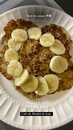 a white plate topped with pancakes covered in banana slices