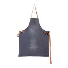 an apron with leather straps hanging from the side on a white background, it is also used as a tool holder