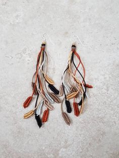 Fall in love with these stunning long Boho earth tone earrings.  These neutral dangle earrings will compliment any Autumn wardrobe perfectly and make a wonderful gift for her.   🧡 Hand knotted in 12 strands of silky soft 1mm rattail cord on stamped 925 sterling silver wires, they are lightweight and easy to wear in stunning gold, copper, silver, black and taupe.  Do you see feathers, leaves or ears of wheat?  🧡 Length:  Approx 5"/13cm 🧡 Ready to post within 2 working days.  Send direct as a g Macrame Leaf Tutorial, Macrame Leaf, Earrings Macrame, Crazy Plant Lady, Macrame Patterns Tutorials, Micro Macramé, Macrame Earrings, Fall Earrings, Rainbow Earrings