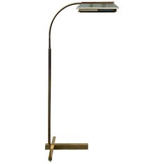 a floor lamp that is on top of a wooden stand with a light bulb in the middle