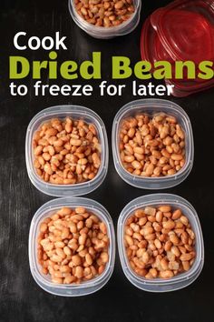 four plastic containers filled with baked beans on top of a black table next to a red bowl