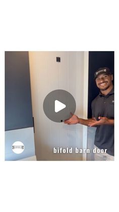 a man standing in front of a white door with the words bifold barn door on it