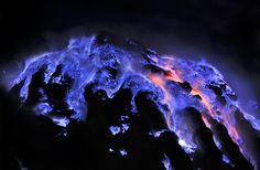 a mountain covered in blue and orange flames