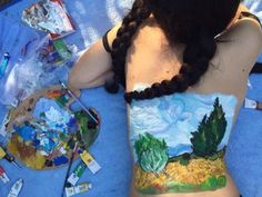 a woman with her back to the camera is painted