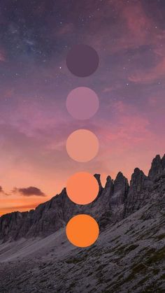 the sky is full of stars and there are five circles above it, with mountains in the background