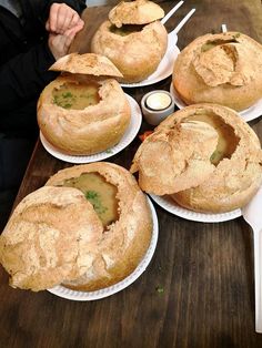 several pies sitting on top of white paper plates