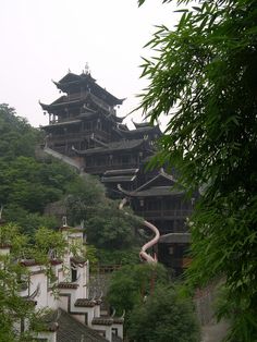 an old building on the side of a hill with many stairs leading up to it