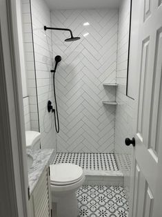 a white toilet sitting next to a walk in shower