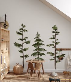 there is a table and chairs in the room with pine trees on the wall behind it