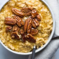 a bowl filled with oatmeal topped with pecans