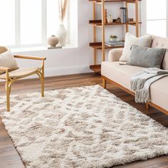 a living room with a couch, chair and bookshelf