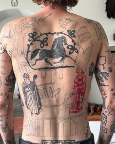 the back of a man with tattoos on his body and horse drawn on his chest