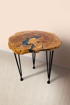 a wooden table with hairpin legs and a blue paint on it's surface