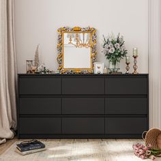 a dresser with a mirror and flowers on it