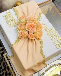 a birthday cake decorated with flowers and gold sequins