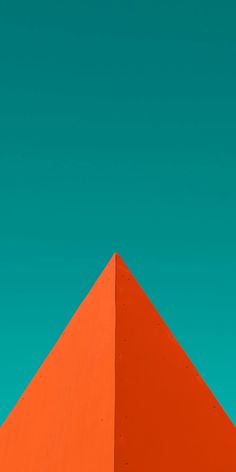 an orange triangular shaped structure against a blue sky with a bird perched on it's side