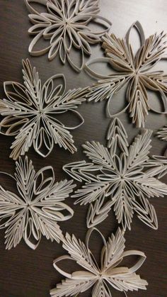 paper snowflakes are arranged on a table