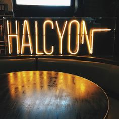 the word halcyon is lit up on top of a table