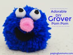 a close up of a stuffed animal with the words adorable diy grover pom pom