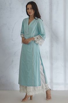 Featuring a light blue kurta in cotton base with lace detailing. It is paired with matching palazzo pants.  FIT: Fitted at bust and waist. COMPOSITION: Cotton. CARE: Dry clean only. Lace Kurta, Lace Designs On Suits, Pakistani Kurta Designs, Cotton Suit Designs, Stylish Kurtis Design, Lace Suit, Blue Kurta, Lace Dress Design, Latest Dress Design