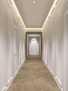 an empty hallway with wooden floors and white walls, leading to the exit door that leads to another room