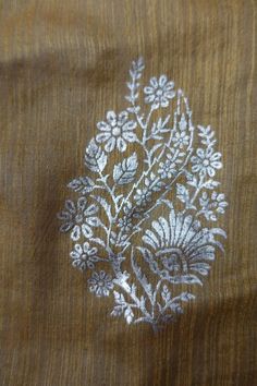 an embroidered piece of cloth with flowers on it