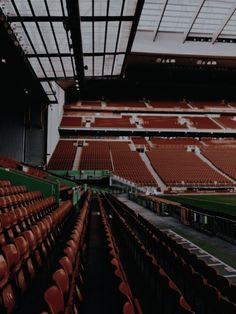 an empty stadium filled with red seats