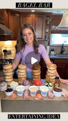 a woman standing in front of a counter filled with food