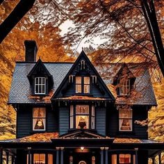 a black house in the fall with leaves on the ground and trees around it's edges