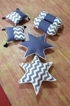 four star shaped pillows laying on the floor