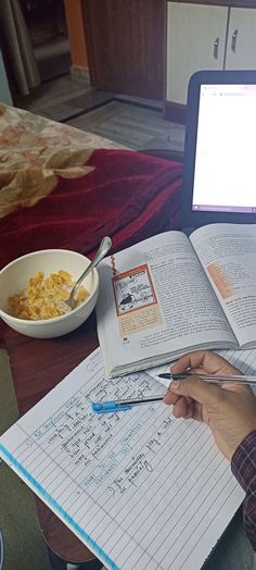 an open book sitting on top of a table next to a bowl of oatmeal