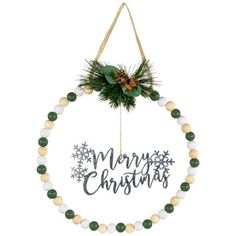 a christmas ornament hanging on a wall with snowflakes and pine cones