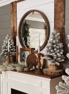 a fireplace mantel decorated with christmas trees and candles