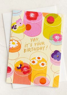 a birthday card with an image of colorful cups and flowers on the front that says yay, it's your birthday