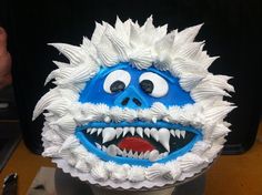 a cake with white frosting and blue icing on it's face is decorated like a monster