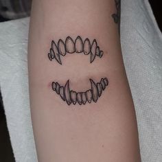 a tattoo on the arm that has three hearts and two letters in it, all connected together