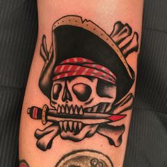 a skull and crossbones tattoo with a pirate's hat on his arm