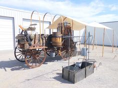 an old fashioned horse drawn carriage sitting in front of a building