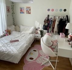 a bedroom with a bed, desk and chair in it's corner next to a window