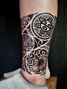 a black and white tattoo on the leg of a person with a butterfly in it