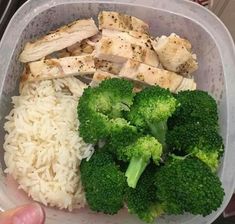 a plastic container with rice, broccoli and chicken on it in someone's hand