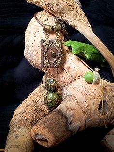 a close up of a stuffed animal on a tree branch with other items around it