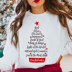 Names of Jesus Christmas Tree Sweatshirt Hand Lettered Holiday Crewneck  Religious Word Art Design  Christian Sweatshirt Color of shirt is White. Printing process is Direct to Garment aka DTG. All shirt are made to order. Please double check sizing before placing your order. Cotton Blend. Classic fit. Unisex sizing, so it fits more loose than woman sizing. Sizes: S, M, L, XL, 2XL, 3XL  Size chart is in photos for reference. Care Instructions. Wash inside out on a gentle cycle in cold water.  Hang to dry or tuble dry on a low heat setting. DO NOT Dry Clean or use bleach. Questions. Please let me know if you have any questions or concerns. Jesus Christmas Tree, Girls Modest Fashion, Holiday Crewneck, Jesus Sweatshirts, Jesus Christmas, Word Art Design, Christian Girl, Christmas Tree Shirt, Christmas Jesus