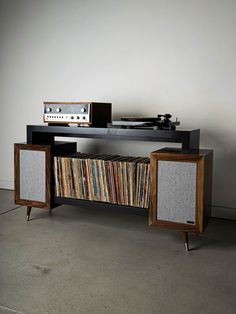 an old record player sitting on top of a table next to a record player and cabinet